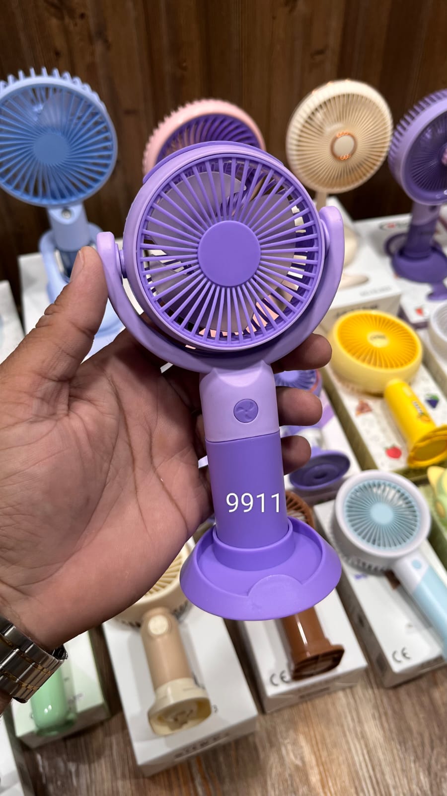Portable Purple Handheld Mini Fan With a Desk Stand and Button Controls