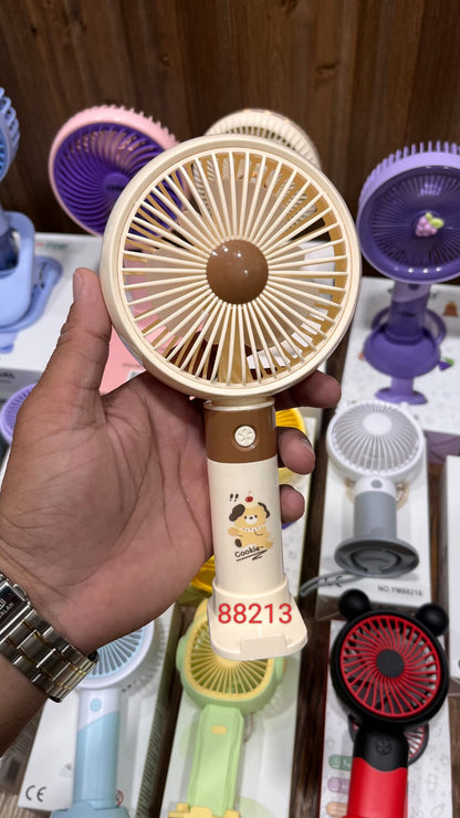 Portable Rechargeable Fan in a beige color with a cartoon design on the handle