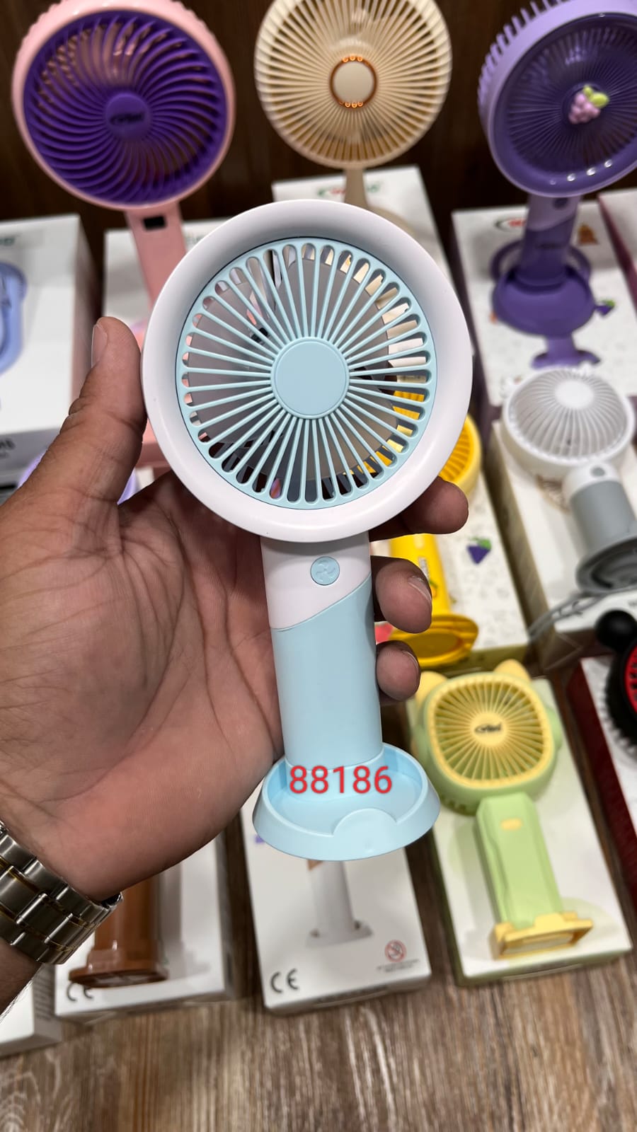 Rechargeable, portable handheld and desktop mini fan with a blue and white design