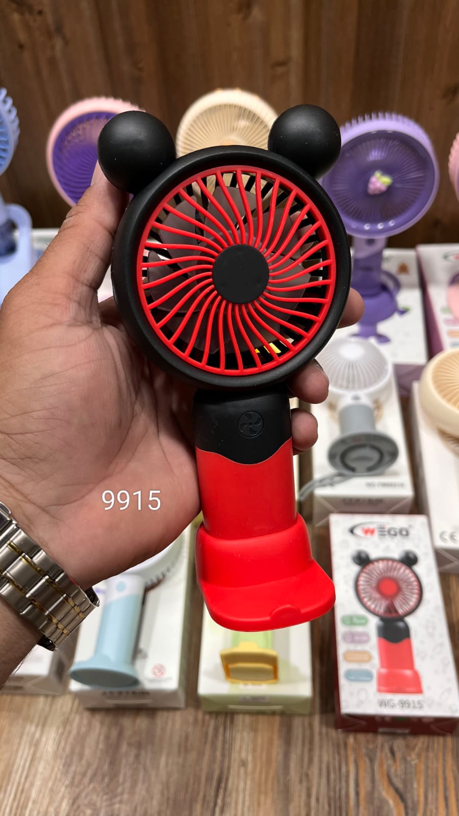 Red and black Mickey Mouse-themed handheld USB fan available