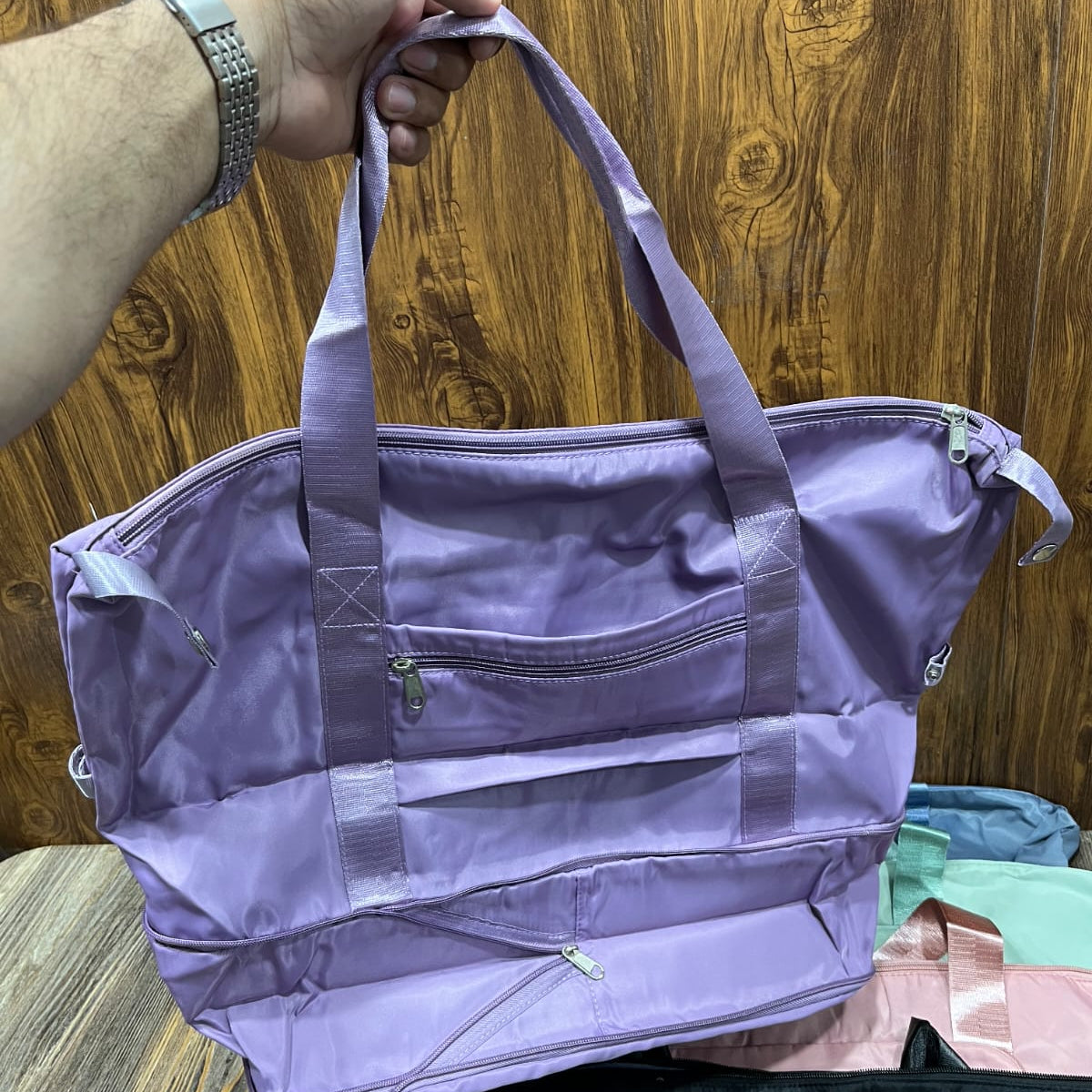 Hong Fu branded lilac purple foldable travel bag made from lightweight waterproof fabric.